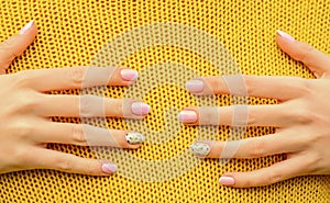 Hug concept. Beautiful hands touching knitted background. Spa and nail care. Healthy nails. Nail art manicure. Beauty