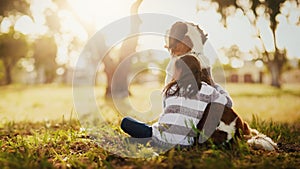 Hug, dog and girl child in outdoor park for affection, friendship or cuddle pet in nature. Back, animal and young kid