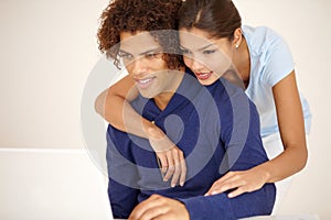 Hug, happy and couple on laptop for online shopping, browse internet and social networking together. Dating, love and