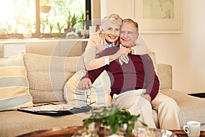 Hug, love and portrait with senior couple on sofa in living room of retirement home together for bonding. Happy, relax