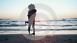 Hug, sunset and couple with silhouette, beach and adventure with commitment, travel and marriage. People, man and woman