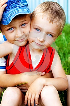 Hug of two cute brothers outdoor