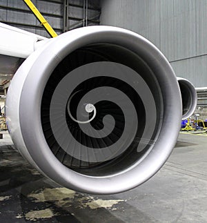 a huge aircraft engine during maintenance inside a hangar