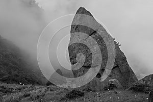A huge ancient monolith with extrange texture in middle of colombian countryside photo