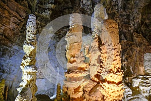 Huge ancient stalagmites closeup in the cages of Grotta di Frasassi, Genga, Marche, Italy.