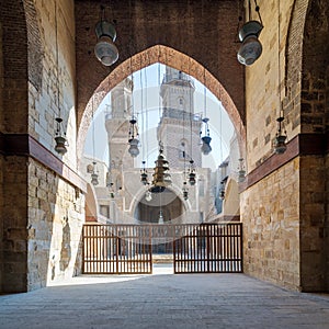 Huge arch revealing patio of Mamluk Sultan Al Nassir Qalawun mosque and two minarets, Cairo, Egypt photo
