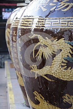 Huge big large oriental clay pot vase with a dragon carving