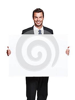Huge billboard for your awesome product. A handsome young businessman holding a blank board while isolated on white.