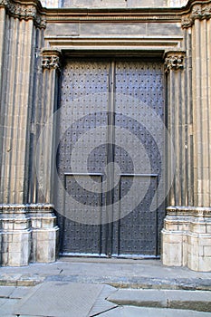 Huge black wooden doors of church in Barcelona