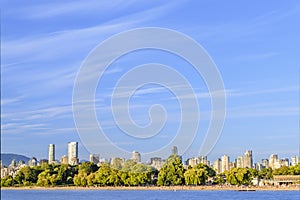 Huge blue sky with clouds, a modern seaside town with mountains