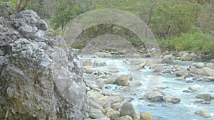 Huge Boulder Keeping Watch on the Flowing Hot Water Stream at a Forest