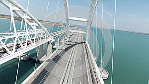 Huge bridge. Drone view. Action. A long bridge over the ocean on which cars can move freely, the bridge is located next