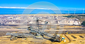 A huge bucket-wheel excavator digging coal on the open-pit mine.
