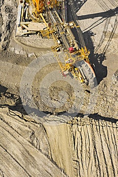 Huge bucket wheel excavator or mobile strip mining machine mining coal in a quarry. Heavy industry concept