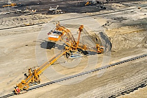 Huge bucket wheel excavator or mobile strip mining machine mining coal in a quarry. Heavy industry concept