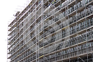 Huge building facade with scaffolding, construction site