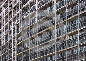 Huge building facade with scaffolding, construction site