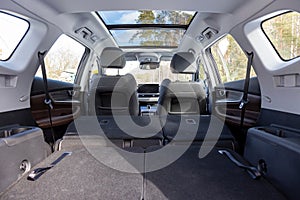 a huge car interior with the rear seats folded down. large luggage compartment of a family car. car folding seats and