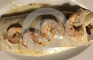 A huge cheesy burrito topped in shrimp - MEXICAN FOOD