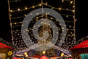 Huge Christmas tree and Cologne Cathedral during Weihnachtsmarkt, Christmas Market in KÃ¶ln, Germany.