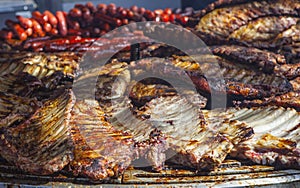 Circular grill loaded full of pork ribs photo