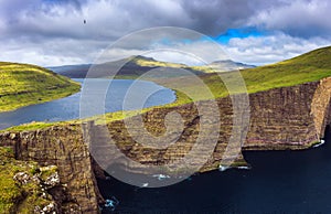 Huge cliff and lake Sorvagsvatn on island of Vagar, Faroe Islands, Denmark. photo