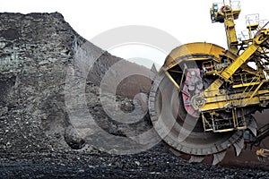huge coal excavator mining wheel in brown mine