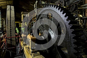 Huge cog wheel in industrial hall