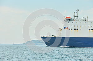 Huge container tanker ship carrying truck size colourful containers in deep blue open ocean sea