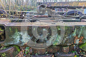 Huge corroded, rusty and peeling metal structure with wheels of a old train bogie