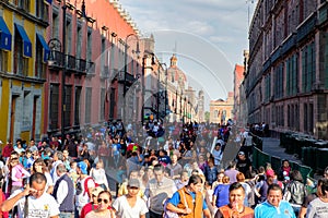 Huge crowd and colorful buildings at the historic center of Mexico City