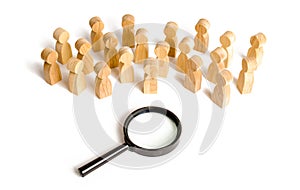 Huge crowd of people stand near a magnifying glass on a white background. Search for work. Human resources, management. concept photo