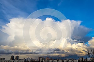 Huge cumulonimbus cloud over the city, in the evening.