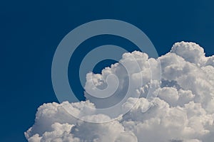 Huge cumulonimbus high in the blue sky