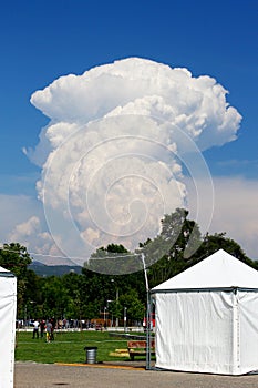 Huge cumulus cloud rising high in the blue sky