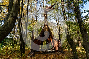 Huge dinosaur model in the forest. Dinosaur in the jungle