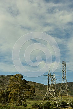 Huge dramatic high voltage electric cables spoiling nature