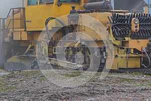 A huge dust cloud in the center of a big city during the operation of the auxiliary railway machine.