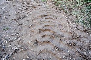 Huge excavator tyre traces on the soil and mud