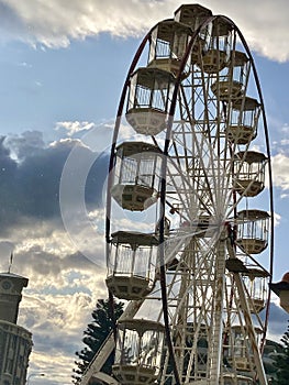 huge ferris wheel, on a sunny day with blue sky and clouds photo
