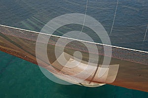 Huge fishing net is pulled up by ropes in a traditional fishing trabucco in Italy