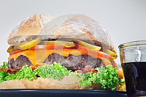 Huge giant homemade cheeseburger for burger party, horizontal