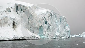 Huge giant iceberg and ice floe in ocean of Antarctica.