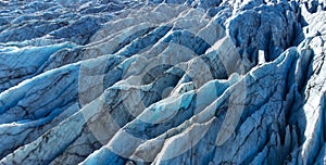 Huge glacier with pure blue ice at sunny weather. Vatnajokull glacier covered snow in Iceland. Beautiful nature abstract