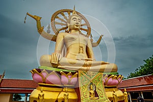 Huge golden color statue of buddha in the temple. Thailand