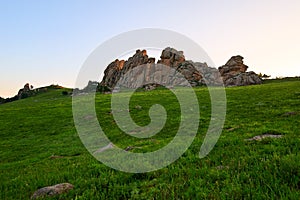 The huge granite on the alpine meadow sunset