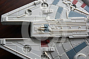 A huge gray spaceship of the future with instruments and equipment is located on a dark brown wooden background.
