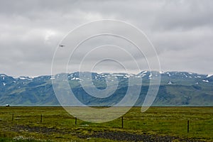 Huge green empty field with view to mountain