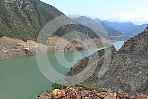 Huge green river surrounded with mountaines