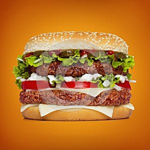Huge hamburger over orange background